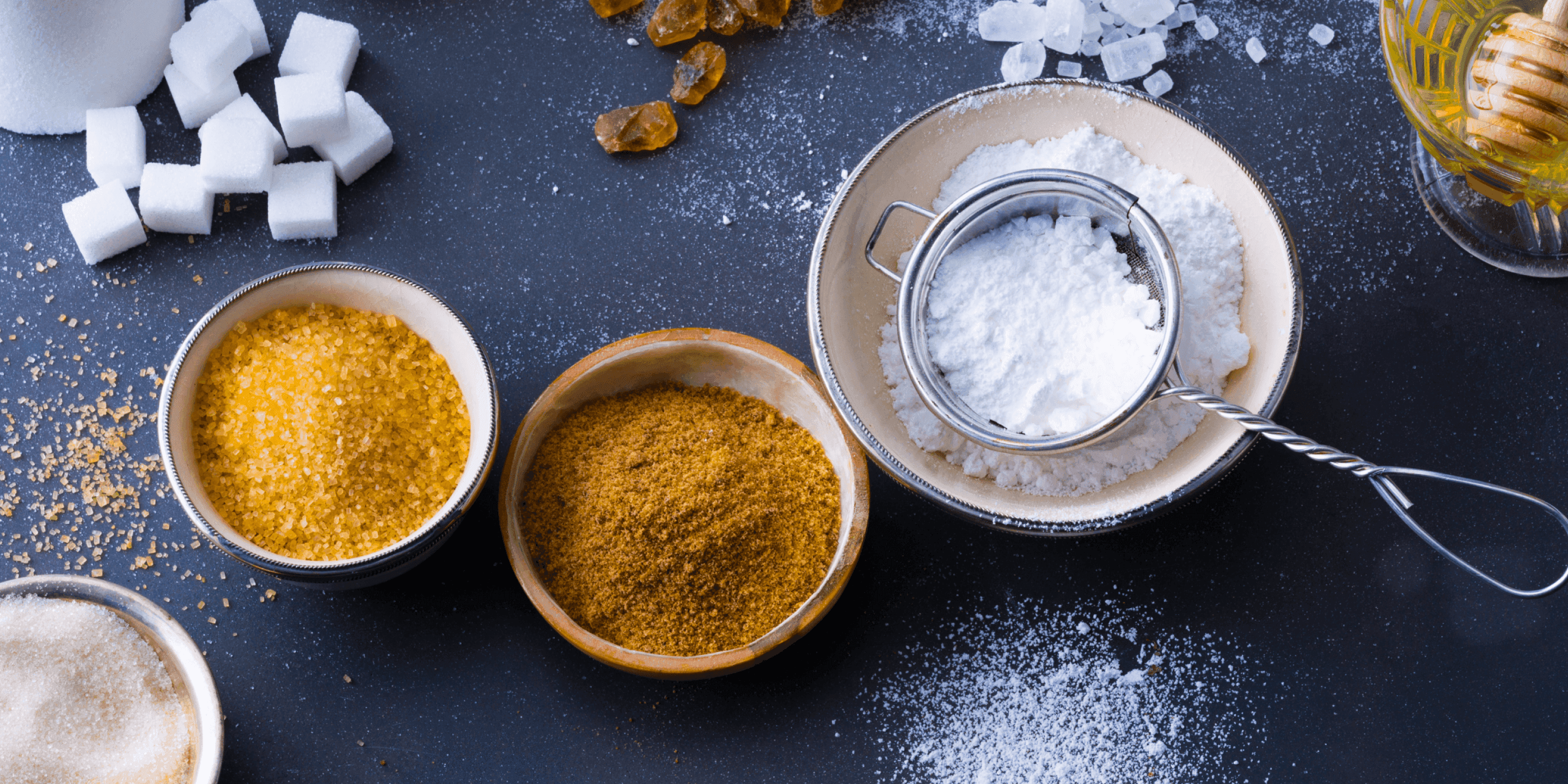 Bowls containing different types of sugar. 
